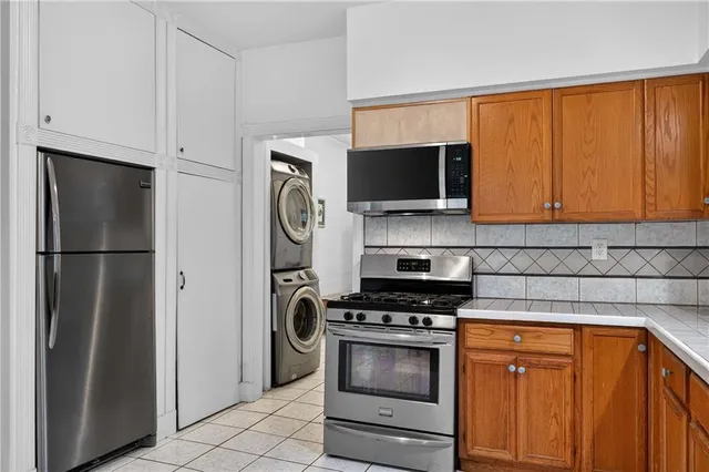 a kitchen with stainless steel appliances a refrigerator stove and microwave