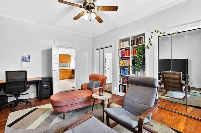 a living room with furniture a flat screen tv and a window