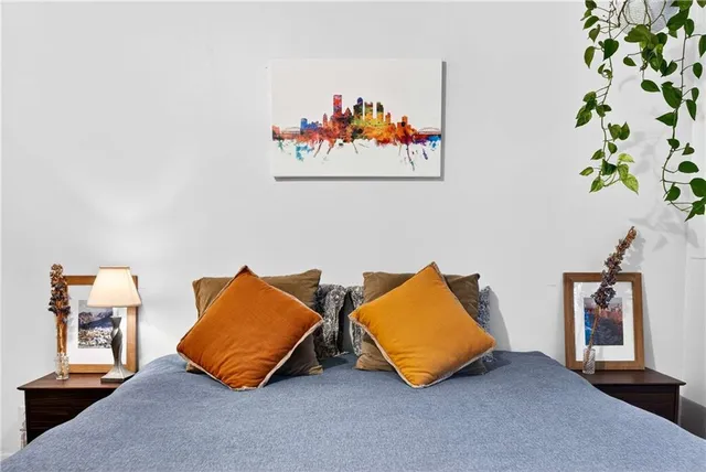 a room with wooden floor and a potted plant