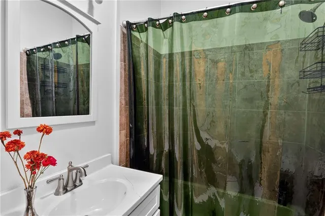 a bathroom with a shower and a sink