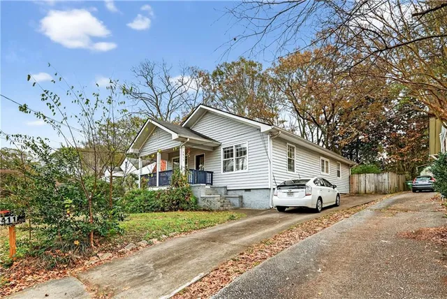 a white house in the middle of a yard