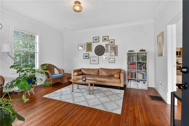 a living room with furniture and a wooden floor