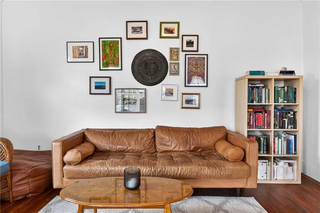 a living room with couches a book shelf and a book shelf