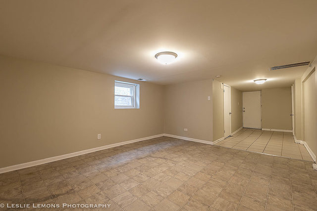 5331 West Addison Street Chicago, IL 60641 - Photo 26 of 32 an empty room with a white wall & windows
