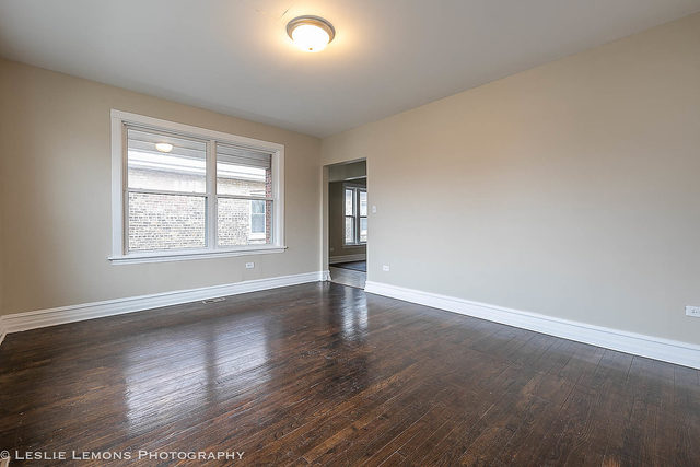 5331 West Addison Street Chicago, IL 60641 - Photo 6 of 32 an empty room with wooden floor and windows