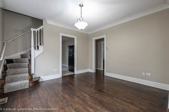 5331 West Addison Street Chicago, IL 60641 - Photo 7 of 32 a view of an empty room with wooden floor and stairs