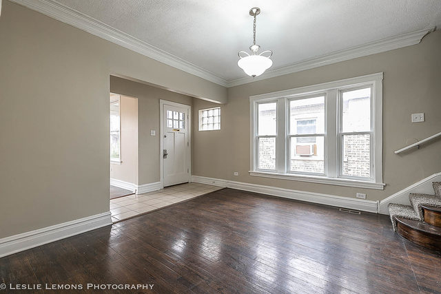 5331 West Addison Street Chicago, IL 60641 - Photo 8 of 32 an empty room with wooden floor and windows