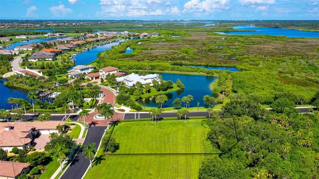 an aerial view of lake residential house with outdoor space and trees all around