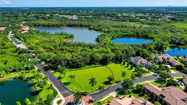 an aerial view of a golf course with a lake view