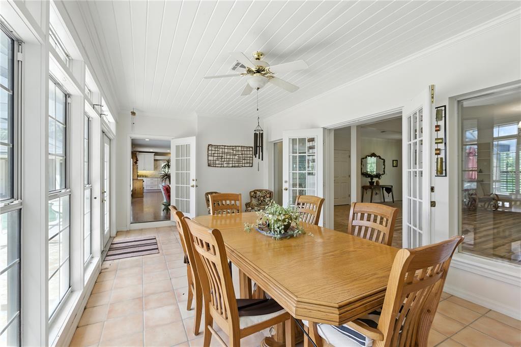 36641 Blanton Road Dade City, FL 33523 - Photo 11 of 76 a view of a dining room and livingroom with furniture wooden floor a chandelier