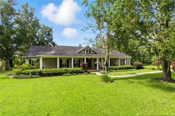 a view of a house with a yard porch and sitting area