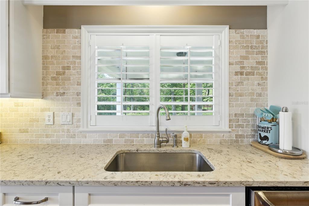 36641 Blanton Road Dade City, FL 33523 - Photo 25 of 76 a kitchen with granite countertop a sink and a window