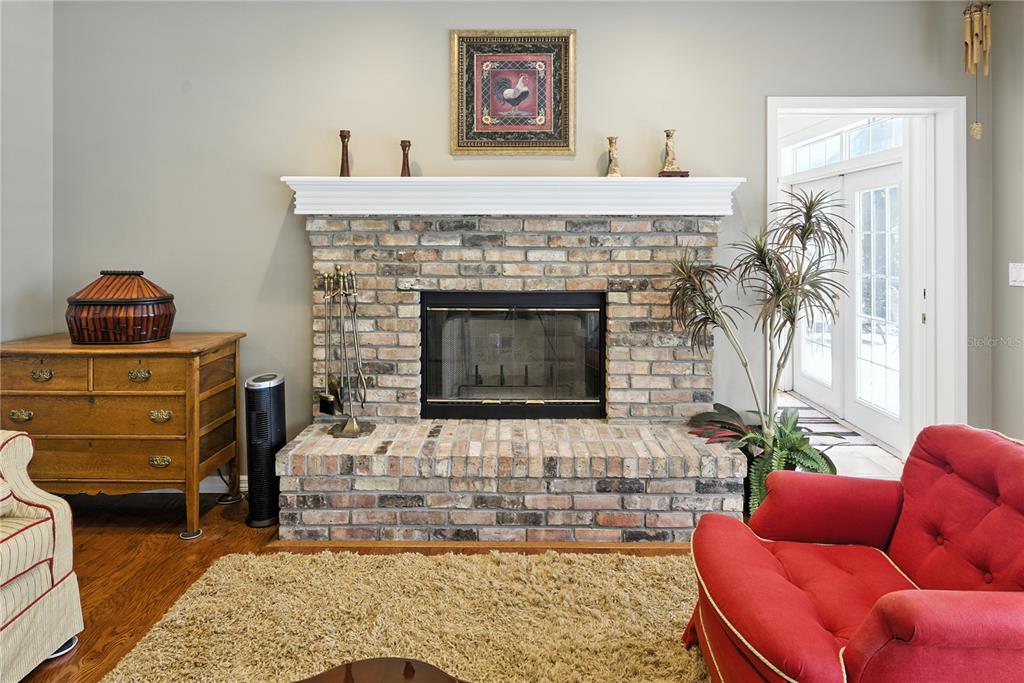 36641 Blanton Road Dade City, FL 33523 - Photo 29 of 76 a living room with furniture and a fireplace