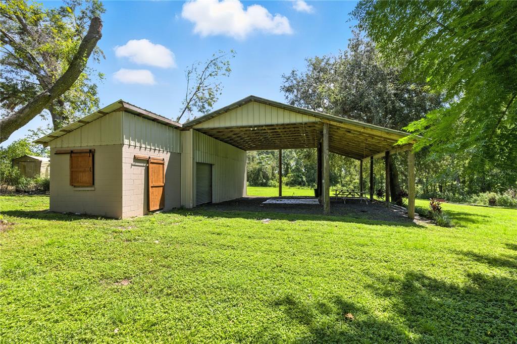 36641 Blanton Road Dade City, FL 33523 - Photo 50 of 76 a view of a house with a yard and sitting area