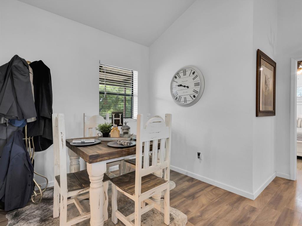 830 Louis Scherer Road Weatherford, TX 76088 - Photo 16 of 36 a view of a dining room with furniture and wooden floor