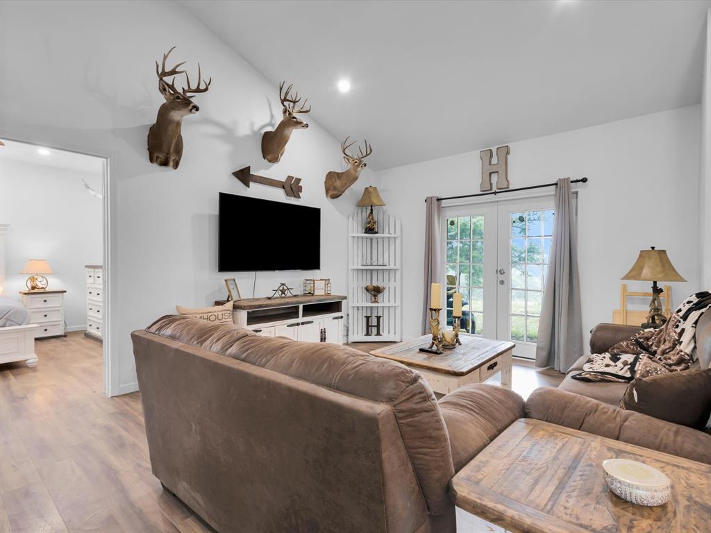 830 Louis Scherer Road Weatherford, TX 76088 - Photo 17 of 36 a living room with furniture and a flat screen tv