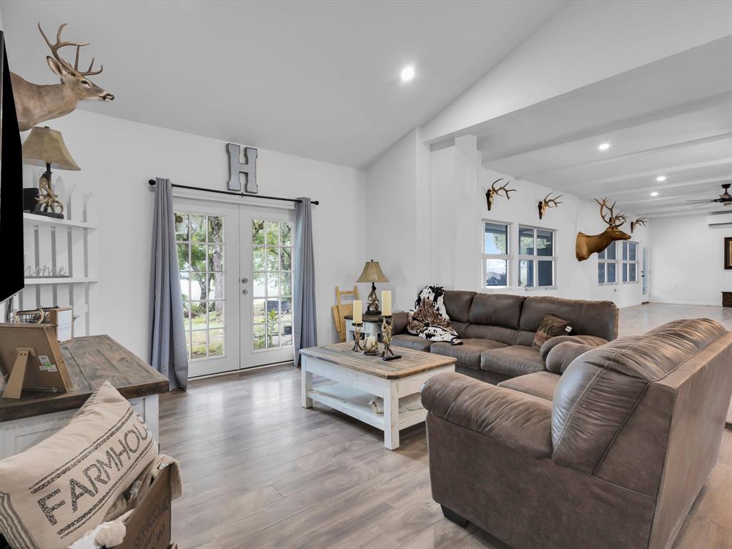 830 Louis Scherer Road Weatherford, TX 76088 - Photo 18 of 36 a living room with furniture and wooden floor
