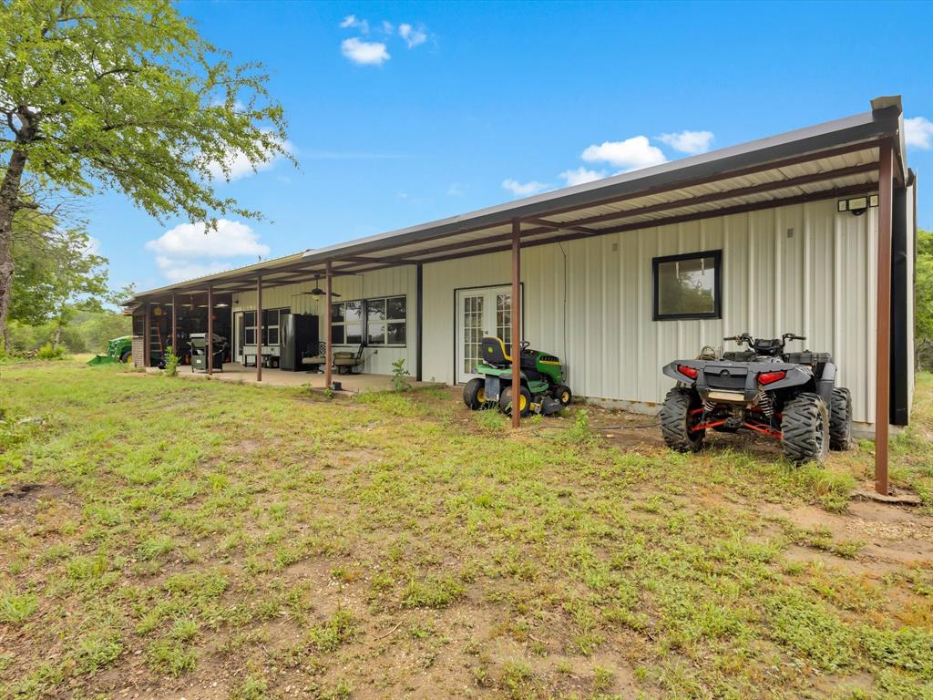 830 Louis Scherer Road Weatherford, TX 76088 - Photo 3 of 36 a view of a patio with table and chairs under an umbrella