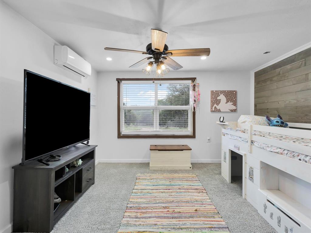 830 Louis Scherer Road Weatherford, TX 76088 - Photo 5 of 36 a living room with furniture and a flat screen tv