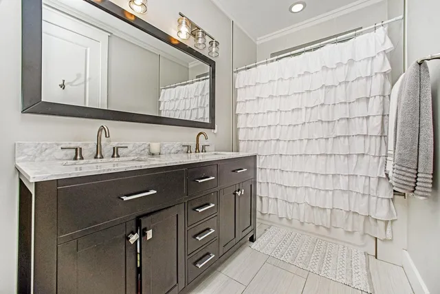 a bathroom with a sink vanity and a mirror
