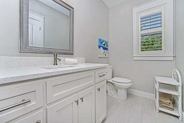 a bathroom with a sink toilet and mirror