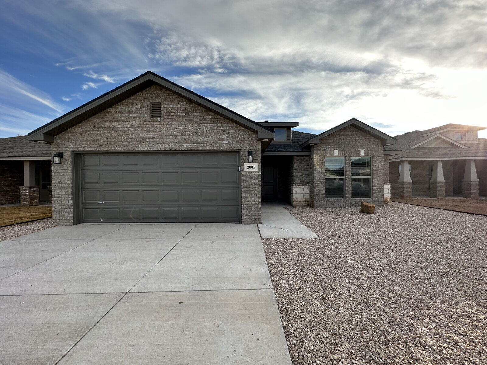 2005 135th Street Lubbock, TX 79423 - Photo 1 of 13 a front view of a house with a yard and garage