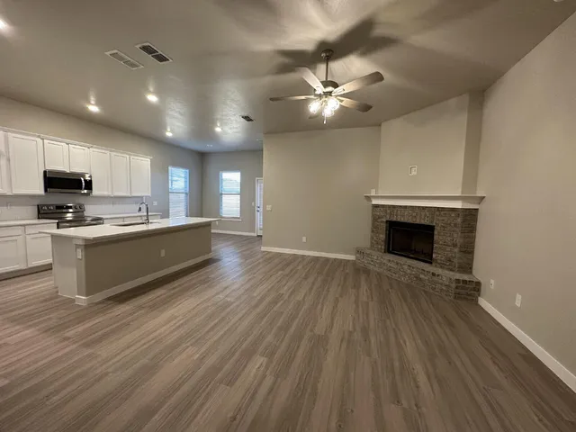 a view of kitchen with sink and wooden floor