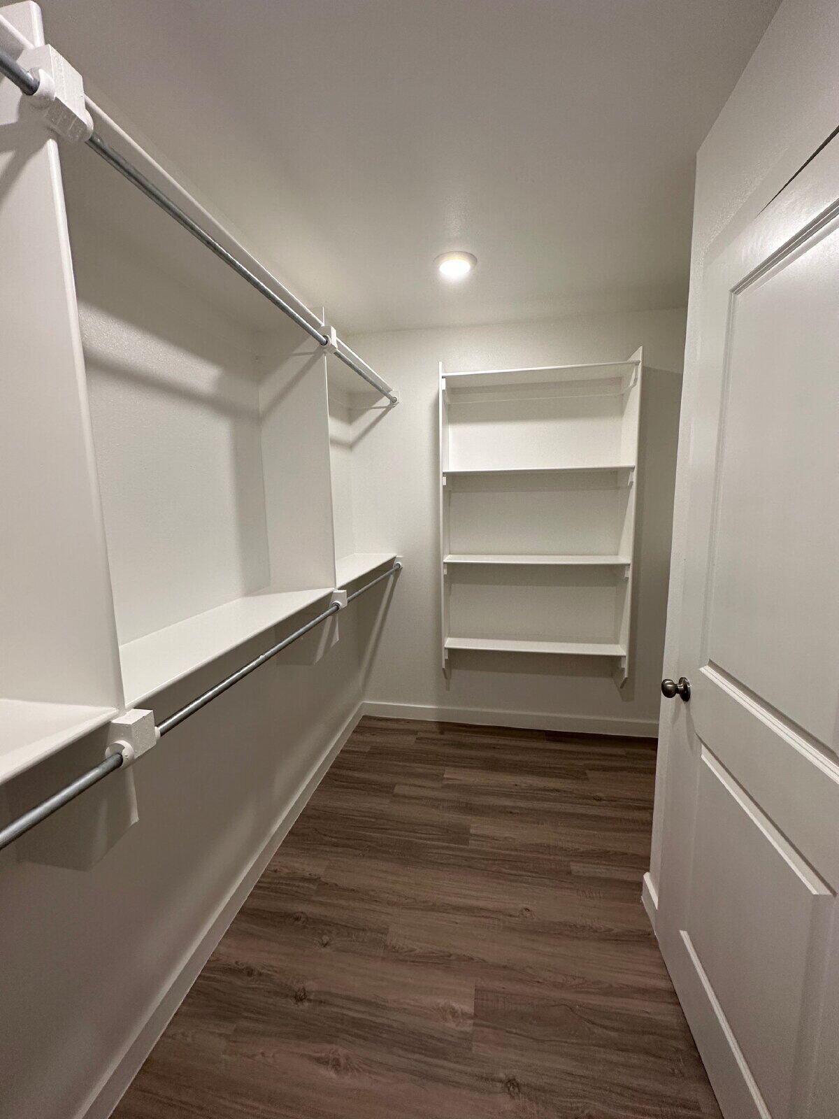 2005 135th Street Lubbock, TX 79423 - Photo 8 of 13 a room with walk in closet and wooden floor