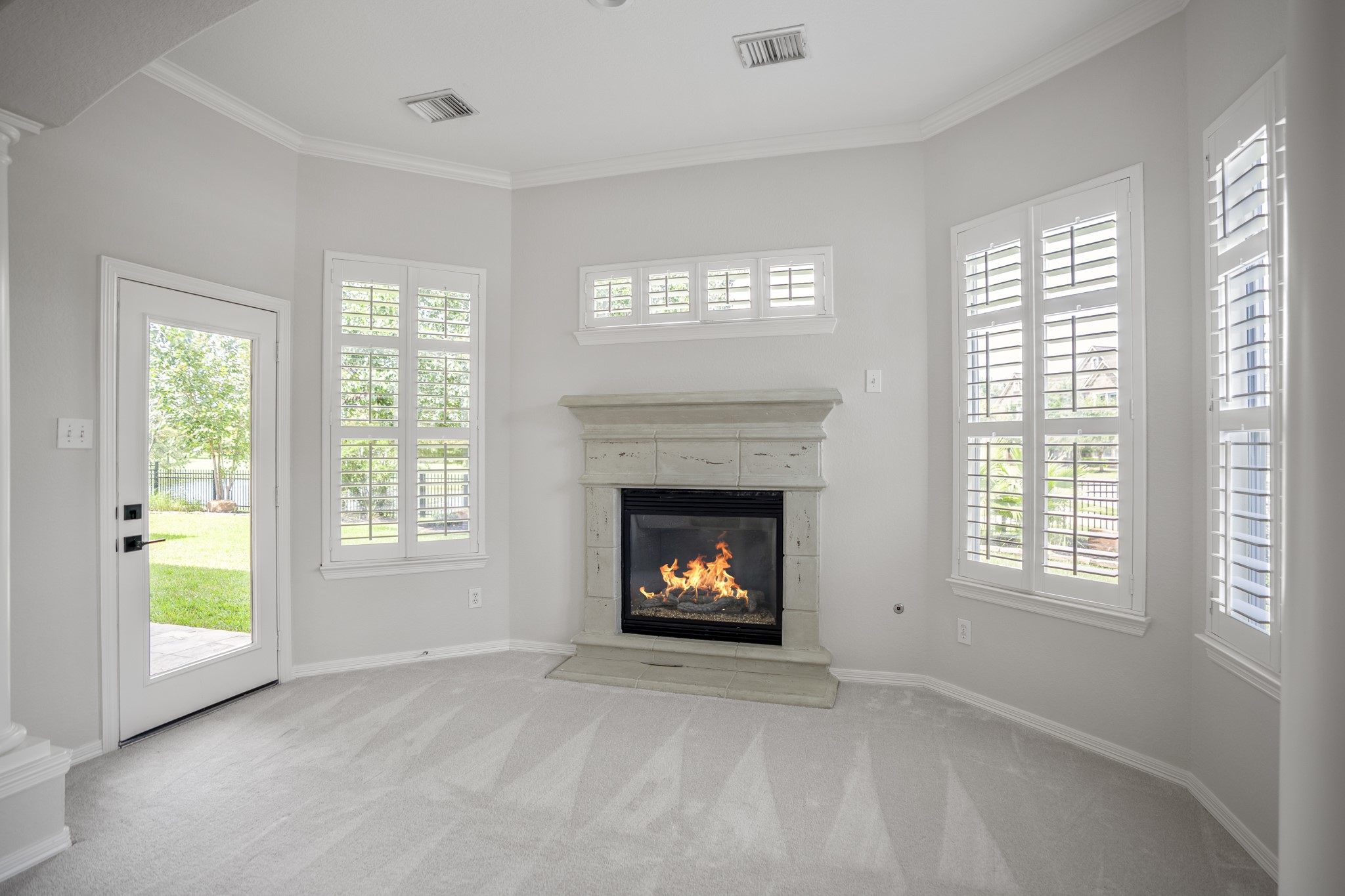 18602 Yorkshire Manor Court Spring, TX 77379 - Photo 22 of 50 a living room with a fireplace and windows