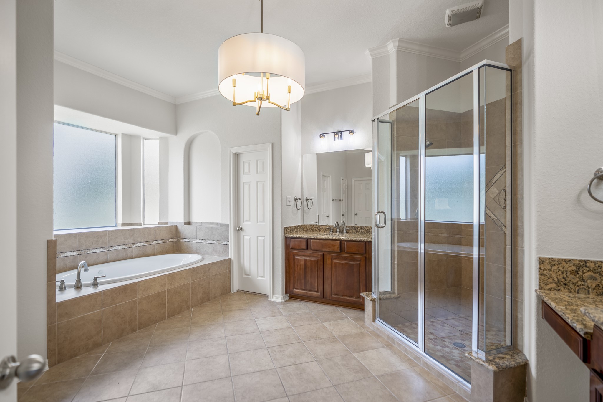 18602 Yorkshire Manor Court Spring, TX 77379 - Photo 25 of 50 a spacious bathroom with a granite countertop tub sink and mirror