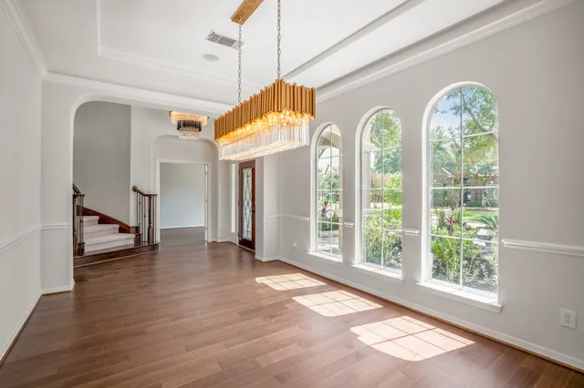 a view of a room with wooden floor and windows