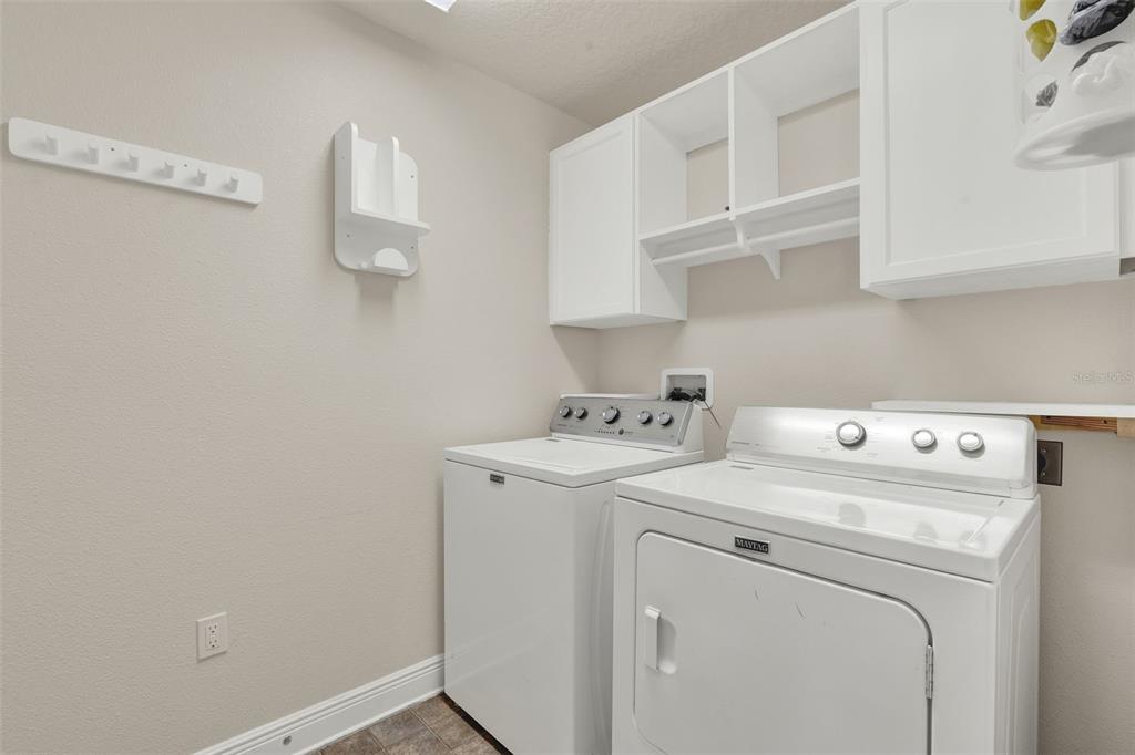 4229 Barnsley Lane Tavares, FL 32778 - Photo 17 of 20 a view of storage and utility room with washer and dryer