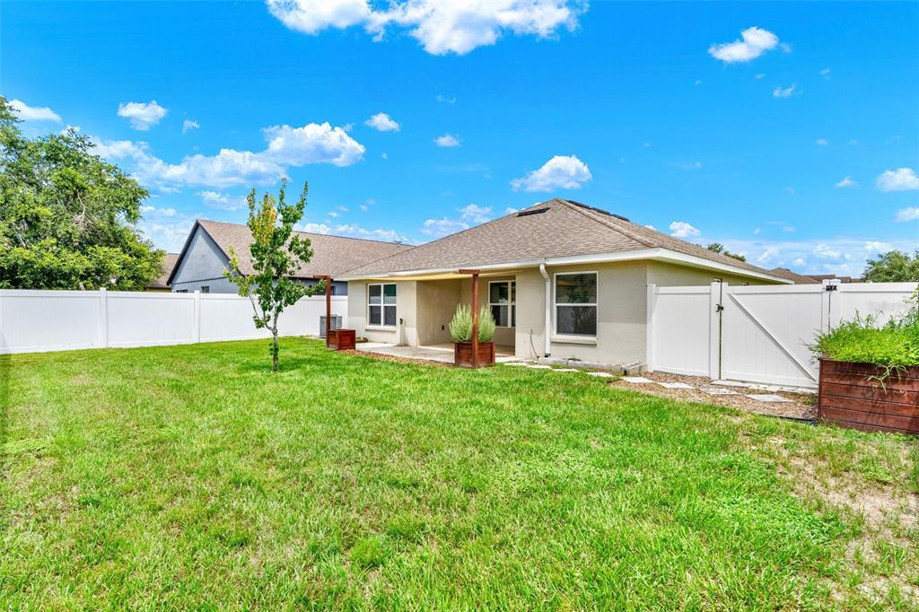 4229 Barnsley Lane Tavares, FL 32778 - Photo 20 of 20 a view of a house with a yard and sitting area