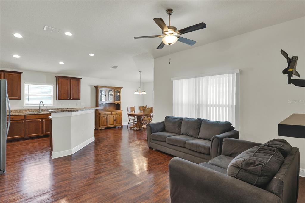 4229 Barnsley Lane Tavares, FL 32778 - Photo 5 of 20 a living room with furniture kitchen and a wooden floor