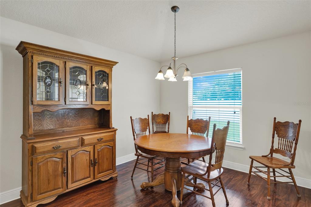 4229 Barnsley Lane Tavares, FL 32778 - Photo 6 of 20 a view of a dining room with furniture window and wooden floor