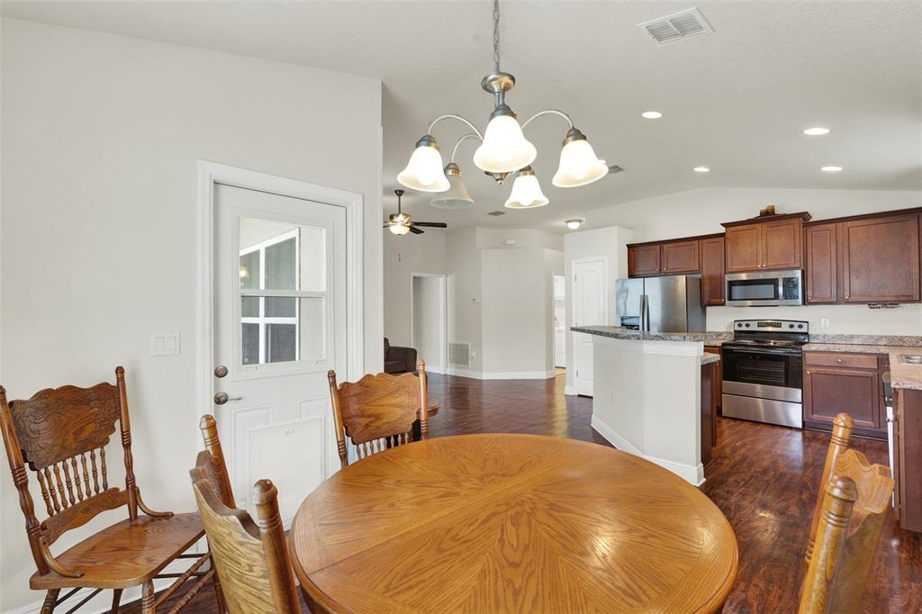 4229 Barnsley Lane Tavares, FL 32778 - Photo 7 of 20 a view of a dining room with furniture and wooden floor