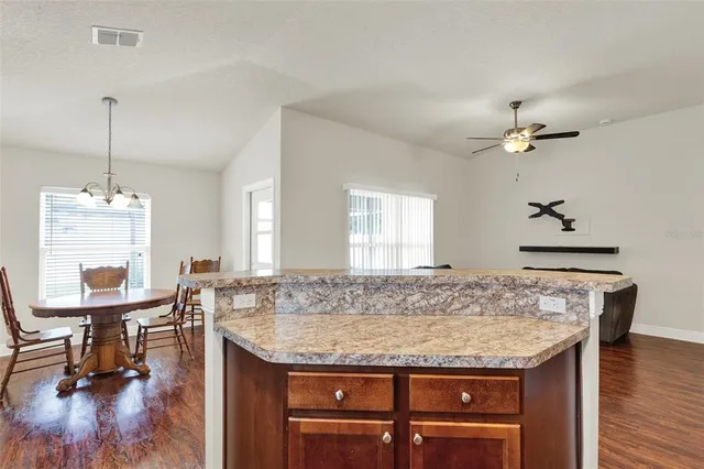 a dining table with chairs and wooden floor