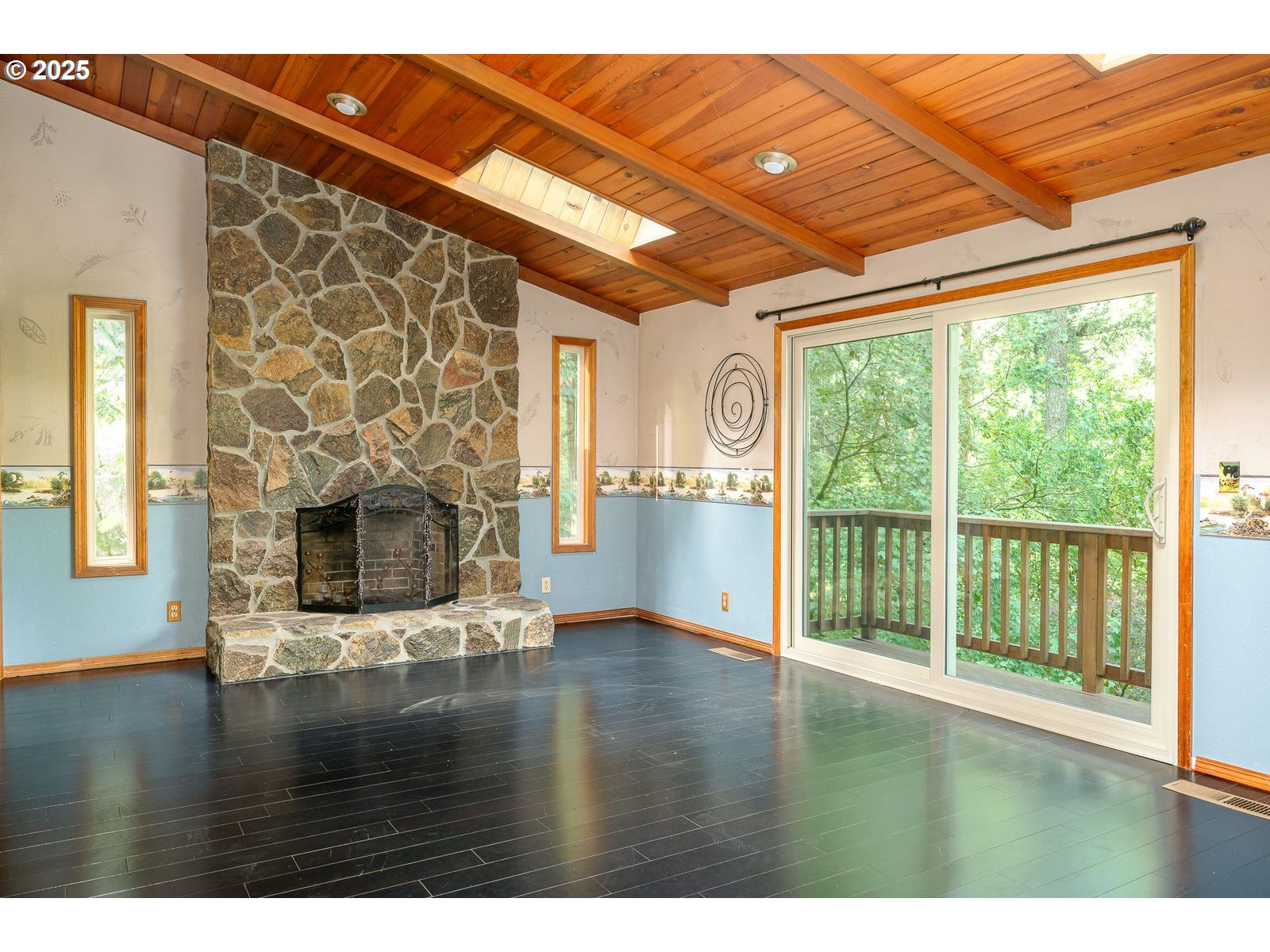 18335 Southeast 370th Avenue Sandy, OR 97055 - Photo 12 of 42 a view of empty room with wooden floor and fireplace