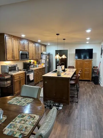 a kitchen with stainless steel appliances granite countertop a refrigerator stove microwave and sink