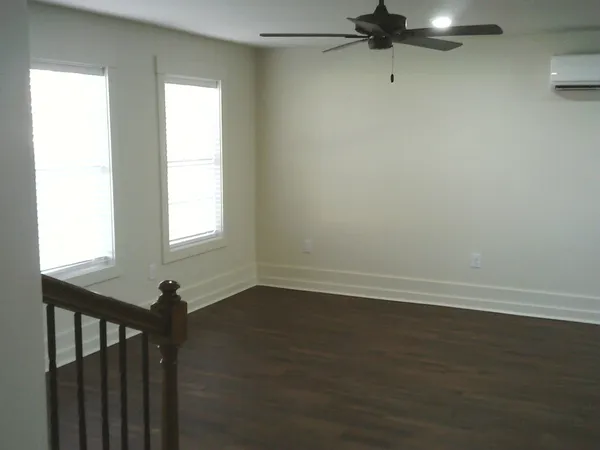 a kitchen with stainless steel appliances a sink cabinets and wooden floor