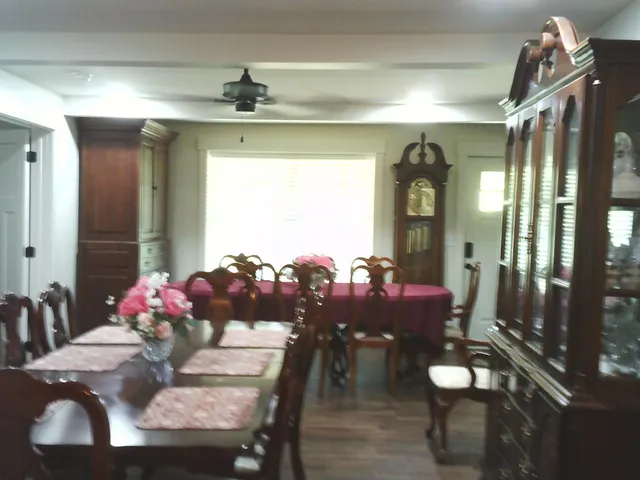 a view of a dining room with furniture and chandelier