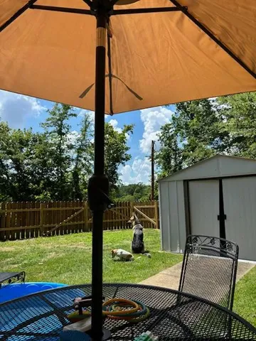 a view of a wooden deck with a yard