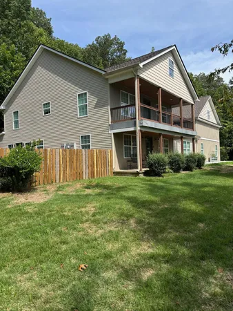 a view of a house with backyard and garden
