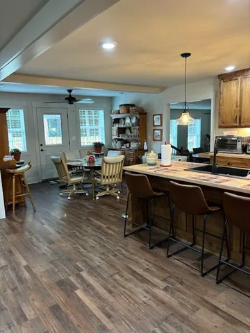 a room with lots of wooden furniture table and chairs