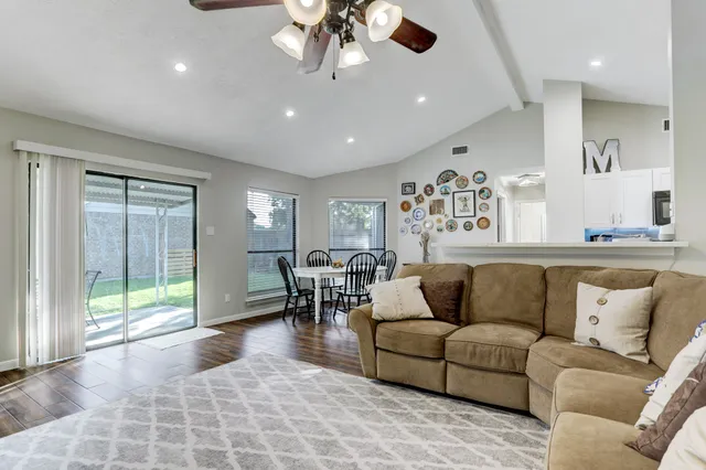 a spacious bathroom with a double vanity sink a toilet and a mirror
