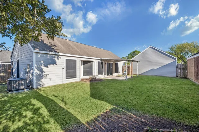 a view of a house with a backyard
