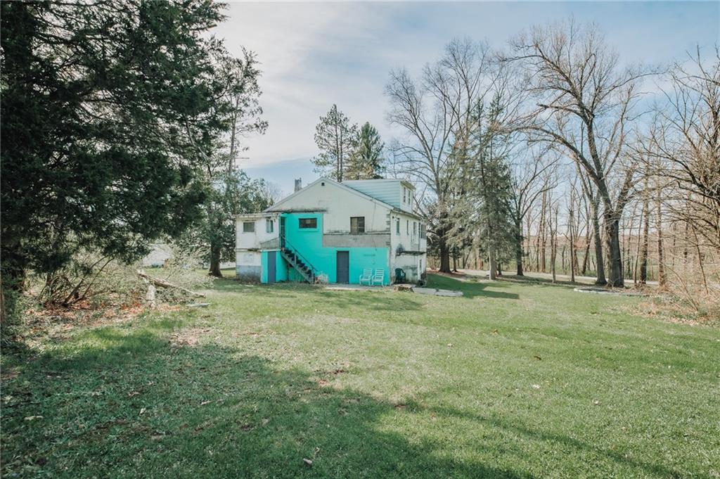 1313 Herman Road Cabot, PA 16023 - Photo 8 of 37 a big house with trees in front of it