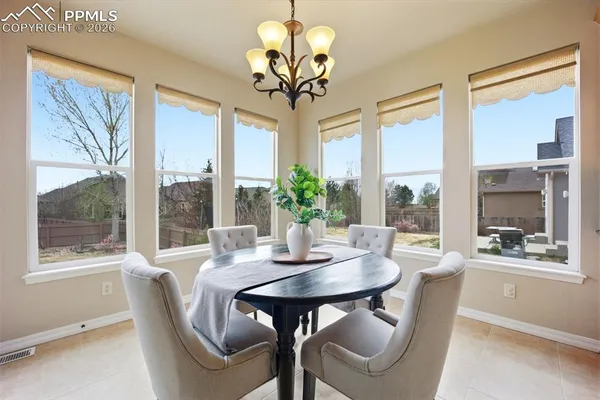 a dining room with furniture a chandelier and a rug