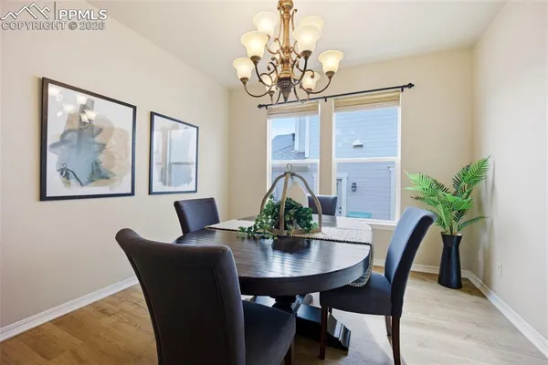 a dining room with furniture and chandelier