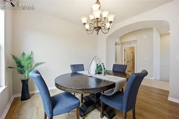 a view of a dining room with furniture wooden floor and chandelier